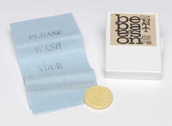 (.1) White plastic box with Maciunas-designed label attached to the lid; contains (.2) a blue...