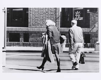 Back view of Roberta and man walking.