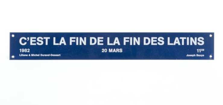 Title of the work is in white letters on blue background with a hole in each of the four corners...