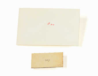 white paperboard with handwritten word "sky" on front in pencil.