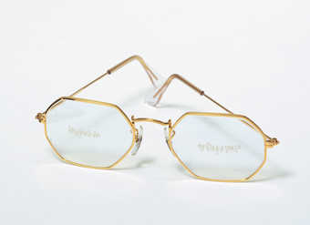 gold-rimmed Ray Ban glasses engraved with the following:  front left lens - "long...