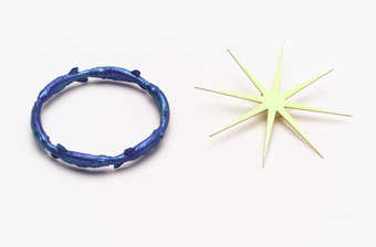 A circular bracelet of blue fish and a yellow pin of a star.
