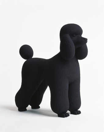 A plaster poodle with a matte black finish.