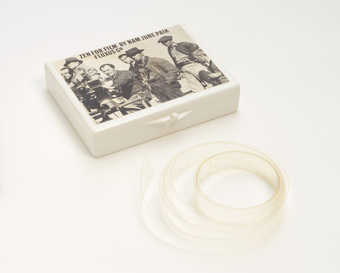 (.1) White plastic box with Maciunas-designed label attached to lid; (.2) contains a  blank 16mm...