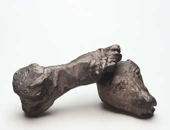 A roughly modeled human foot and animal head.