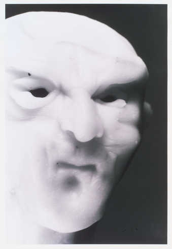 portrait of white fimo clay figure with black background