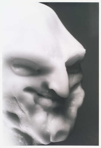 portrait of white fimo clay figure with black background