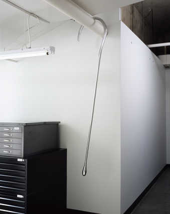 A polished aluminum shepherds crook.