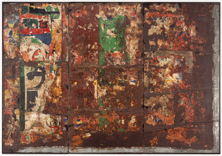 Torn advertisement posters adhered to rusted sheet metal, nailed to wood