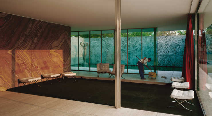 An image of a man cleaning the interior windows of the Van der Rohe Foundation in Barcelona