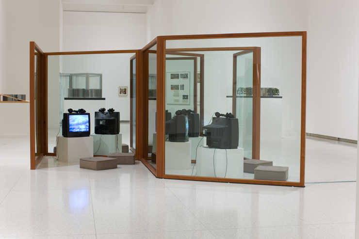 A series of glass panels in Mahogany frames that interconnect to form partitioned spaces for...