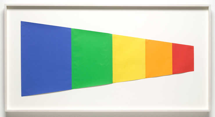 A horizontal trapezoid created from vertically oriented sheets of colored paper.  Contained...