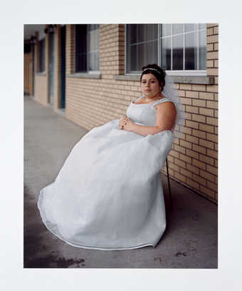 An image of seated bride